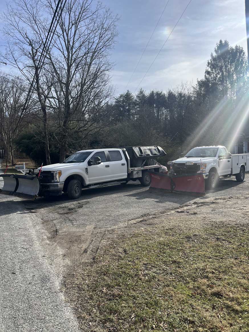 JRW Services crew trucks staged before a storm, ready for lot and sidewalk clearing